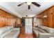 Spacious living area featuring wood-paneled walls, comfortable seating, and access to outdoor views at 2044 Yucca Dr, Decatur, GA 30032
