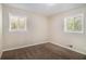 Cozy bedroom with neutral carpet, two windows offering great light, and simple decor at 2925 Heather Dr, Atlanta, GA 30344