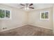 Bright bedroom with neutral carpet, two windows, ceiling fan, and neutral paint at 2925 Heather Dr, Atlanta, GA 30344