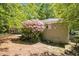 Backyard view showcasing a lush azalea bush, brick exterior, and partial fence line at 2925 Heather Dr, Atlanta, GA 30344