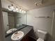 Bathroom featuring a well lit vanity with a clean sink and a standard white toilet and shower at 323 Seasons Pkwy, Norcross, GA 30093