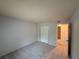 This is a spacious carpeted bedroom with a sliding door closet and neutral paint at 323 Seasons Pkwy, Norcross, GA 30093