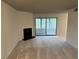 Spacious living room has a fireplace, neutral carpet, and sliding glass doors leading to an outdoor patio at 323 Seasons Pkwy, Norcross, GA 30093