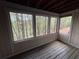 Enclosed porch with views of surrounding greenery and a wooden floor at 323 Seasons Pkwy, Norcross, GA 30093