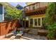 Outdoor patio with stone paving features a wrought iron spiral staircase with lounge chairs, offering a serene outdoor living space at 334 Sutherland Ne Pl, Atlanta, GA 30307