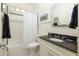 Bathroom featuring a tub, black and white tile floor, and dark countertop sink at 334 Sutherland Ne Pl, Atlanta, GA 30307