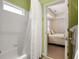 Bathroom with a tub and shower, and view of a bedroom through the door at 334 Sutherland Ne Pl, Atlanta, GA 30307