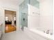 White tiled bathroom with separate shower and tub at 334 Sutherland Ne Pl, Atlanta, GA 30307