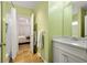 Bathroom with a white vanity and view of a bedroom through the door at 334 Sutherland Ne Pl, Atlanta, GA 30307
