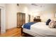 Bright bedroom with hardwood floors and a decorative cabinet for storage at 334 Sutherland Ne Pl, Atlanta, GA 30307