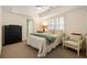 Bright bedroom with neutral tones, tray ceiling, and large window, creating a serene and inviting space at 334 Sutherland Ne Pl, Atlanta, GA 30307
