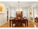 Spacious dining room features a large table, hardwood floors, and ample natural light, perfect for entertaining guests at 334 Sutherland Ne Pl, Atlanta, GA 30307