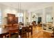 Elegant dining room boasts hardwood floors, a large wooden table, and a decorative hutch for a warm, inviting atmosphere at 334 Sutherland Ne Pl, Atlanta, GA 30307