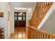 Bright foyer with wood floors, a beautiful front door, and a staircase with wood banister at 334 Sutherland Ne Pl, Atlanta, GA 30307
