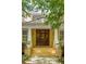 Elegant front entrance with a custom wood door, brick steps, and decorative planters at 334 Sutherland Ne Pl, Atlanta, GA 30307