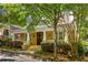 Inviting home showcasing a wide front porch, well-maintained landscaping, and mature trees at 334 Sutherland Ne Pl, Atlanta, GA 30307