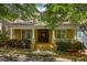 Charming home featuring a classic front porch, brick facade, and manicured landscaping at 334 Sutherland Ne Pl, Atlanta, GA 30307