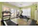 Bright gym room featuring tile floors, a ceiling fan, and exercise equipment including a treadmill and rowing machine at 334 Sutherland Ne Pl, Atlanta, GA 30307