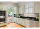 Well-lit kitchen with stainless steel appliances, sleek countertops, and direct access to an outdoor deck at 334 Sutherland Ne Pl, Atlanta, GA 30307