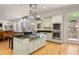 Open kitchen with a large island, stainless steel appliances, and plenty of natural light, ideal for culinary enthusiasts at 334 Sutherland Ne Pl, Atlanta, GA 30307