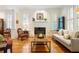 Comfortable living room with a fireplace, hardwood floors, and well-placed windows at 334 Sutherland Ne Pl, Atlanta, GA 30307