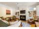 Inviting living room with a fireplace, built-in shelves, and comfortable seating, ideal for relaxation and gatherings at 334 Sutherland Ne Pl, Atlanta, GA 30307