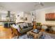 Open-concept living room with hardwood floors, a comfortable sofa, and seamless flow to the adjacent kitchen at 334 Sutherland Ne Pl, Atlanta, GA 30307