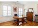 Bright home office with hardwood floors, large windows, and wooden desk with ample workspace at 334 Sutherland Ne Pl, Atlanta, GA 30307