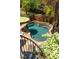 Inviting kidney-shaped pool with a stone waterfall feature, surrounded by lush landscaping and palm trees at 334 Sutherland Ne Pl, Atlanta, GA 30307