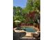 Backyard Kidney shaped pool with an umbrella, stone border, and well-manicured landscaping for a private retreat at 334 Sutherland Ne Pl, Atlanta, GA 30307