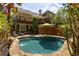Backyard pool with stone surround, deck, and lush landscaping offers a private oasis at 334 Sutherland Ne Pl, Atlanta, GA 30307
