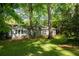 Backyard with green grass and mature trees around the exterior of the home at 1002 Forrest Blvd, Decatur, GA 30030