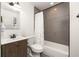 Bathroom with shower and bathtub, dark wood vanity, and decorative patterned floor at 1002 Forrest Blvd, Decatur, GA 30030