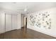 Bedroom featuring hardwood floors, closet, modern ceiling fan and floral wallpaper at 1002 Forrest Blvd, Decatur, GA 30030