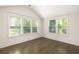 Bright bedroom featuring hardwood floors and large windows offering scenic outdoor views at 1002 Forrest Blvd, Decatur, GA 30030