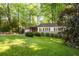 Cozy single-story home with a well-manicured lawn and mature trees at 1002 Forrest Blvd, Decatur, GA 30030