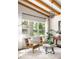 Bright living room featuring exposed beams, modern furnishings, and large windows offering scenic outdoor views at 1002 Forrest Blvd, Decatur, GA 30030