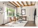 Bright living room featuring exposed beams, modern furnishings, and large windows offering scenic outdoor views at 1002 Forrest Blvd, Decatur, GA 30030