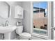 Powder room with white fixtures, modern faucet, and a storage cabinet above the toilet at 2482 Crescent Park Ct, Atlanta, GA 30339