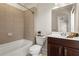This bathroom features a shower-tub combo with tiled walls and a single sink vanity at 2482 Crescent Park Ct, Atlanta, GA 30339