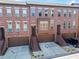 Brick townhome featuring attached garages, steps to the front door, and well-maintained landscaping at 2482 Crescent Park Ct, Atlanta, GA 30339