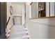 Bright entry foyer with carpeted stairs and dark railings leading to the upper level at 2482 Crescent Park Ct, Atlanta, GA 30339