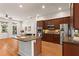 Kitchen with stainless steel appliances, a granite island, and hardwood flooring at 2482 Crescent Park Ct, Atlanta, GA 30339