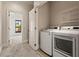 Convenient laundry room equipped with modern washer and dryer, plus ample shelving at 2482 Crescent Park Ct, Atlanta, GA 30339
