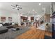 Open-concept living room and kitchen with hardwood floors, a ceiling fan, and a view of the staircase at 2482 Crescent Park Ct, Atlanta, GA 30339