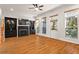 Sunlit living room with hardwood floors, a fireplace, and built-in shelving at 2482 Crescent Park Ct, Atlanta, GA 30339