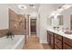 Main bath with double vanity, soaking tub, glass shower and access to walk-in closet at 2482 Crescent Park Ct, Atlanta, GA 30339