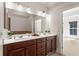 Well-lit main bath featuring double vanity, large mirror, and generous counter space at 2482 Crescent Park Ct, Atlanta, GA 30339