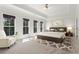 Spacious main bedroom with three large windows, tray ceiling, carpet flooring, and neutral colors at 2482 Crescent Park Ct, Atlanta, GA 30339