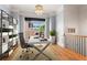 Bright office with large window, modern chandelier, and a bookcase providing ample storage space at 2482 Crescent Park Ct, Atlanta, GA 30339